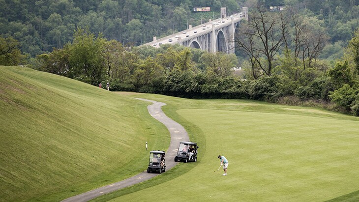 …of John’s approach shot into the par-5 7th hole,...
